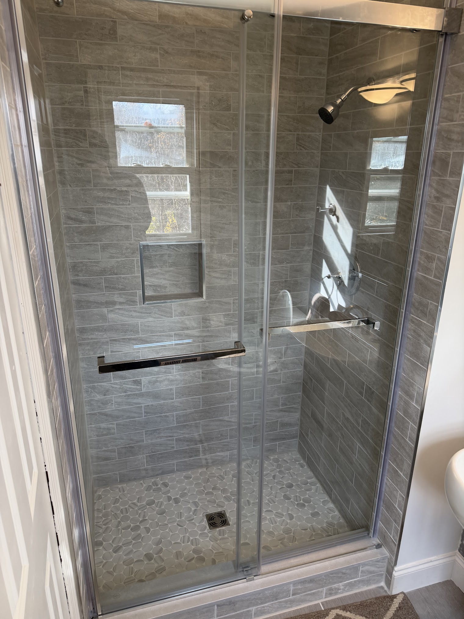 Custom tile shower build with glass door in Monmouth County NJ