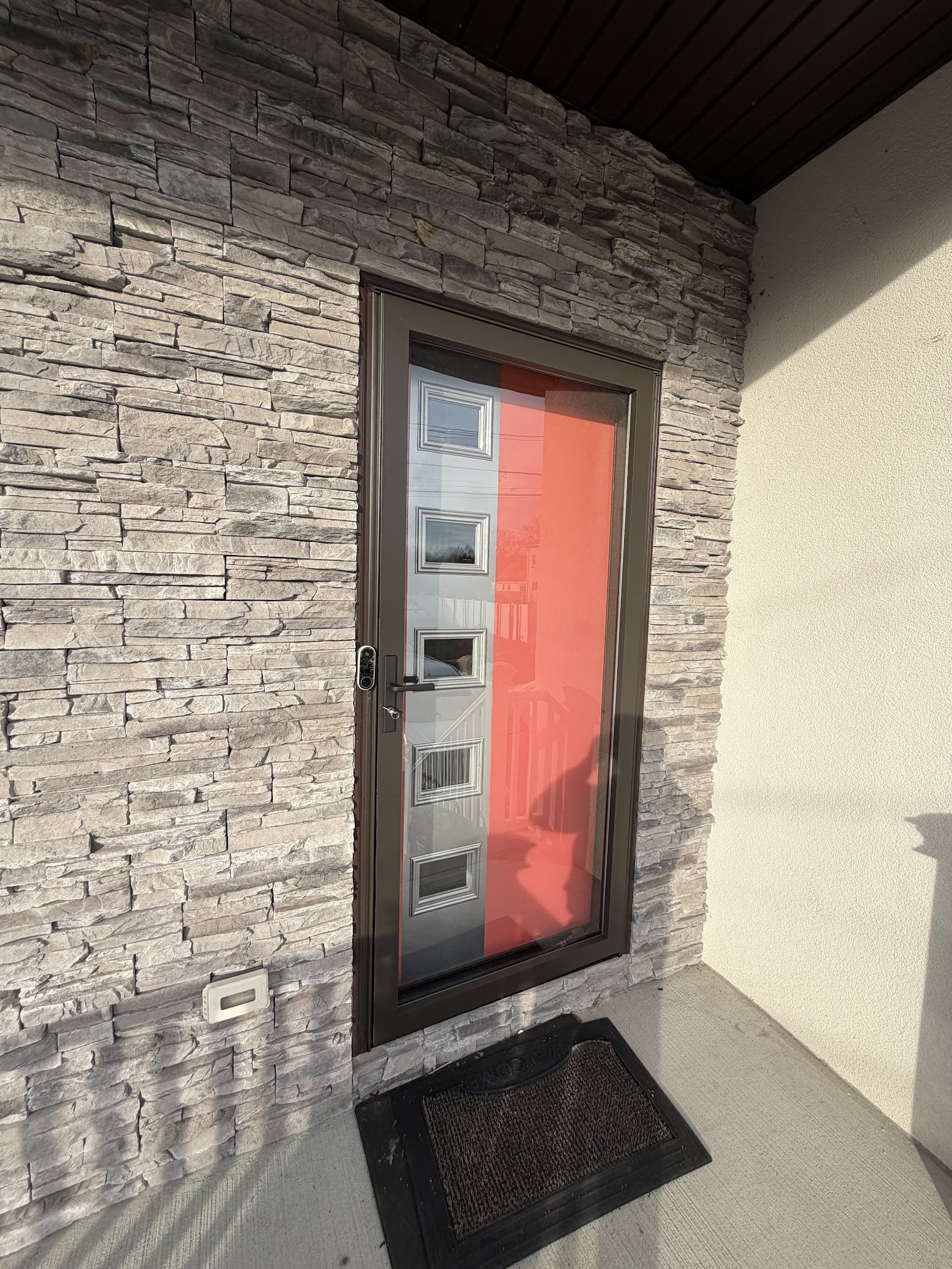Storm door installation on stone front exterior NJ